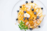 These easy delicious Blueberry Pancakes are loaded with fresh wild blueberries use plain yogurt to make the pancakes super fluffy and flavorful.