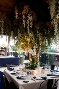 Floral tree installation with greenery, hanging moss and white orchid floral