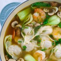 This authentic homemade wonton soup recipe is easy and fun to make! Each hearty bowl is packed with plump pork dumplings, fresh vegetables, and jumbo shrimp. #video #wontonsoup #chinesefood #dumplings