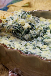 This Spinach Artichoke Dip is so creamy & satisfying with two kinds of cheese and lots of spinach & artichokes.  It’s also one of the easiest dips you will ever make!!  Just heat it in the oven and serve warm with chips or crackers.  It’s a great dip for any get-together!