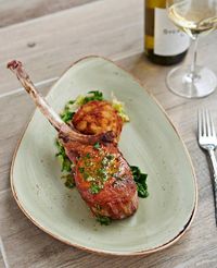 Pork tomahawk chop at Zest with yuca cakes and sauteed escarole. Try a different fritter every day at Cindy Hutson’s Zest downtown Miami