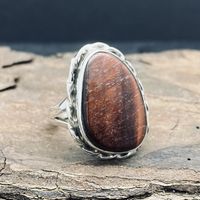 Ring Dimensions: size - 7 stone size - 20mm x 19mm Red tiger eye is thought to be motivational and is connected to the root chakra through its red color.