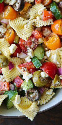 Greek Pasta Salad with Tomatoes, Olives, and Feta. The classic homemade Greek dressing will become a family favorite in your home. This Mediterranean, meatless, vegetarian pasta salad is perfect for a starter, side dish, lunch, or dinner! Make it ahead and share it with your family and friends at summer picnics and potlucks.