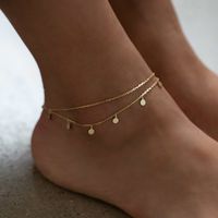 Dress up plain pumps or flats with this chic anklet featuring dangling polished discs on a layered chain. Thick layer of 14K Gold over .925 Sterling Silver 4mm Discs Hypoallergenic, lead, and nickel free Length: 9in (22cm) + Extension: 1in (2.5cm) Lobster clasp closure Handcrafted in NYC #ANK014