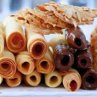 Learn how to make amazing tuiles at home and enjoy them in many ways, such as cigarette cookies, almond tuiles, and ice cream cones!