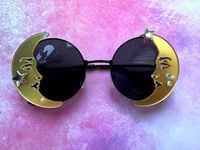 ✨Gorgeous unique eye wear by Alexis Exclusive.. ✨These unusual glasses are the perfect accessory for adding that special touch to your outfits. ✨The frames are round black metal and they have tinted dark lenses. On either end they have a gold large mirrored moon embellished with metal stars and a few rhinestones. ✨Great for festivals, holidays, special occasions or everyday wear.. .  ✨UV protection. ✨Exclusive design made by myself, you won't see any others like these anywhere else. ✨All my glas