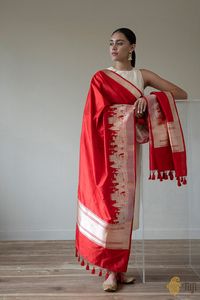 "Kashi Dupatta\nBanaras - it leaves you speechless, then turns you into a storyteller. Inspired by our captivating, challenging and endlessly fascinating city, this is a handloom masterpiece and handwoven art...For an ode to pious, timeless and magnificent Banaras can only be written by its extraordinary weaver-poets!\n\n\n\n\n Color\u00a0- A stunning shade of Red\n\n Technique\u00a0- An enduring Kadwa weave. The elaborate and laborious Kadwa (Kadhua) technique involves hand-weaving each motif separately. It takes longer on the handloom, but makes a more robust pattern, which stands out on the fabric.\n\n Fabric\u00a0- Soft as butter, pure Katan silk\n\n Speciality\u00a0- The glorious outline of Varanasi's Ghats, lovingly handwoven on a base of resplendent silk in Roopa Sona or Gold and Si