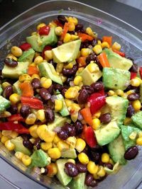 Cowboy Caviar is a melody of black beans, corn, red onion, cherry tomatoes, garlic & avocados marinated in a cilantro lime vinaigrette and served with to...