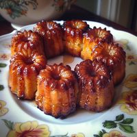 Canelés de Bordeaux Recipe Ingredients: 2 cups (500 ml) whole milk 1 vanilla bean (or 1 teaspoon vanilla extract) 2 tablespoons unsalted butter 1 cup (200 g) granulated sugar 1 cup (125 g) all-purpose flour 2 large eggs 2 large egg yolks 2 tablespoons dark rum 1/2 teaspoon salt 1 tablespoon beeswax (optional, for coating the molds) 1 tablespoon butter (for coating the molds, if not using beeswax) Instructions: Prepare the Batter: In a saucepan, combine the milk, vanilla bean (split and scrap...