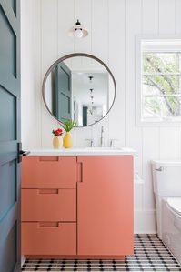 If you have a mostly white bathroom, consider painting your cabinetry a bolder color to add instant personality, says Cortney Bishop of Cortney Bishop of Design. #bathroomideas #bathroomdecor