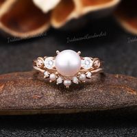 Akoya Pearl Engagement Rings Art Deco Moissanite Wedding Ring Set Antique Pearl Curved Wedding Band Gold Rings For Women Anniversary Ring RING DESCRIPTION ✦Engagement Ring ✴Center Stone - Pearl Shape - Round Cut Size - 7mm ✴Side Stones - Moissanite Weight - 0.2ct Shape - Round Cut ✴Band Width - About 1.8mm ✦Wedding band ✴Stone - Round Cut - Moissanite & Pearl Weight - 0.06ct ✴Band Width - About 1.5mm ✴Ring Metal:  Available in rose gold plated, yellow gold plated, 925 sterling silver, 10k or 14k