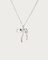 The fusion of a delicate ribbon motif with shimmering cubic zirconia stones elevates the contemporary balletcore aesthetic, providing an elegant addition to any modern ensemble. Materials: platinum plated brass, blue cubic zirconia Measurements: 450mm / 17.72" in length