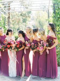 Bridesmaids in berry dresses and Bride in Berta gown with moody colorful bouquet of dahlias, peonies, and ranunculus with pink, red, and peach at Rancho Bernardo Inn. Cavin Elizabeth Photography.