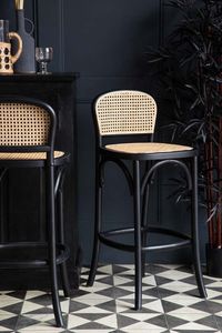 About The Chez Pitou Black Wood & Woven Cane Bar Stool Make your kitchen breakfast bar exude statement style with the glorious Chez Pitou Black Wood & Woven Cane Bar Stool. Showcasing a woven cane backrest and seat with a sturdy footrest in a beautifully dark birch wood frame, this classy bar stool is oozing with chic Parisian style. Displaying one of a kind charm that incorporates an array of natural materials, this statement bar stool would look utterly delightful as a set styled around a kitchen island creating a fabulously social atmosphere. The Chez Pitou Black Wood & Woven Cane Bar Stool measures 92cm in height, 40cm in width & 45cm in depth. The seat has a height of 3cm, a width of 40cm & a depth of 40cm. The seat back is 22cm in height & 33cm in width. The height from floor to foot