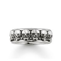 The rocking skull ring is made of blackened 925 sterling silver and is available for both men and women. The ring is framed by numerous three-dimensional skulls, which are detailed and delicately crafted. The top and bottom edges of the ring are embossed with the words "Rebel at heart" and the brand name "THOMAS SABO" in black. The skull ring is the perfect piece of jewellery for anyone who loves expressive and unusual styles. Material 925 sterling silver Width approx. 7.00 mm Thickness approx.