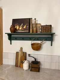 "Add character and functionality to your space with this handcrafted, pine wood peg shelf. Wooden peg shelf with hand crafted corbel ends. Pictured in Basil (color) 36\" (5 peg), this is a versatile shelf that provides both character and functionality to your space. The accent ends on our shelves are hand crafted and not something that can be purchased in a big box store. Each piece is built and painted by hand in our shop. Variations in wood grain make each piece slightly different which adds t