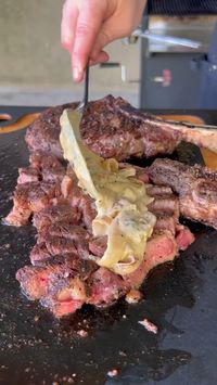 Juicy, bone-in ribeyes are grilled to perfection and topped with a rich, creamy blue cheese onion sauce in this recipe from @grillnation(IG).