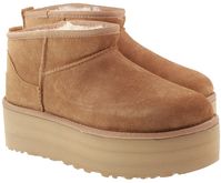 A modern interpretation of our icon, the Ugg Boots Womens Classic Ultra Mini Platform Chestnut reaches new heights with a leg-lengthening 2" platform. Offering a bolder look than ever, it's made with the same rich suede as the original, plus our UGGplush™ wool blend for signature softness. The outsole of this product is either a SugarSole™ outsole, which is a responsible compound using sugarcane foam that allows us to reduce dependency on fossil fuels by replacing petroleum-based ethylene, or a