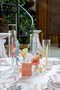 Gorgeous colorful bud vases   you kidding me 🥲 these pastel tapers added so much to this tablescape!! A sweet bud quartet paired with a trio of taper candles is one of our favorite ways to add a little something something to a guest table.  here, we opted for mini centerpieces on some of our farm tables + invested in smilax vines to give life to the venue overall - which is something ALL your guests can enjoy, no matter which table they’re sat at. It’s all about creating an atmosphere!  Planning @perfectlyplannedtx Venue •@theweinbergatwixon Photographer •@allyjoephotography