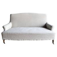 Introducing the Alma Loveseat - a timeless piece crafted for comfort and style. Made with heavy-weight linen and slipcovered in a soothing oatmeal hue, this settee exudes a natural and relaxed elegance. The 18oz linen fabric offers a soft touch, perfect for cozying up with a book or enjoying your favorite TV show. Resembling a classic French Napoleon style sofa, the Alma features turned white oak legs with a medium finish and charming antique-style caster wheels. The machine-washable slipcover ensures easy maintenance, while dry cleaning is recommended for optimal care. Designed for extended seating comfort, the Alma Loveseat is your perfect companion for moments of relaxation and leisure. Fabric: 100% pure linen Color: Greige Natural Size: 72" W x 36.3" D x 39" H Seat Height: 17" Seat Dep