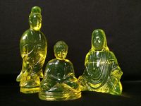 Asian grouping. Back two pieces by Cambridge Glass Company. Front Buddha by Gillinder & Sons.