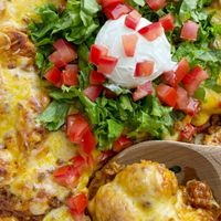 Taco biscuit bake is an easy & simple dinner recipe with refrigerated biscuit dough smothered in a beefy taco mixture and topped with melted cheese.