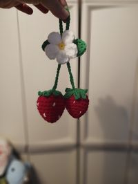 This is a crochet strawberries that hang on your rearview mirror