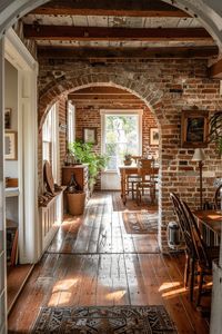 Embrace the coziness of this farmhouse home with a stunning brick archway. Ideal for a warm and inviting living space. #FarmhouseStyle #BrickInterior #HomeDecor #NewEnglandFarmhouse #RusticCharm #HomeInspiration #InteriorDesign #NewEnglandAesthetic