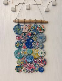 "Gorgeous wall hanging or mobile in fabulous Liberty florals .  This is a new design suggested by the Hubs-- kinda random, kinda funky-- Using gifted new fabric I've fashioned these little \"umbrellas\" into a \"chime-less\" windchime or wall hanging.  It can be used as a wall hanging, a mobile or a fabulous indoor patio flag. Not for outdoor use-- do not get wet... Size is about 10 inches across and 17 inches long (total) :)"