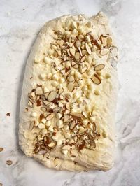 This White Chocolate Almond Sourdough Bread is sweet and flaky, with an irresistible buttery, almond flavor. Stuffed with a homemade almond paste, white chocolate chips and almonds this sweet sourdough mix-in is a must try!