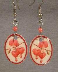 "These lightweight dangle earrings feature a print of a bleeding heart flowers. Handmade altered art Made with acrylic, resin, stainless steel connectors and surgical steel ear wire. Highlighted with glass beads. Measure almost 2\" long (1 7/8) Pay one low shipping price for all items ordered. US orders ship for $3.50 Visit www.afanaffair.com or the 'Wearable Memories' shop section on Etsy to find out how to put your own photos on jewelry Like us on facebook for money saving coupons and offers"