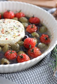 This baked feta appetizer is bursting with flavour. Crunchy bread topped with warm cheese, olives, tomatoes and herbs is hard to resist. An easy recipe for the holidays or year round. Get the recipe on the blog! Baked Feta - Crostini Appetizers - Baked Feta with Olives - Baked Feta Bruschetta