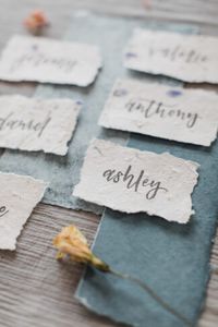 Eco friendly wedding seating place cards on seeded paper, an amazing sustainable alternative to normal paper goods. These eco-friendly wedding place cards can be planted to grow wildflowers and mint, creating a better world rather than creating more waste.  #veganwedding #wedding #weddingideas #confettidaydreams #springwedding #ecofriendlywedding #sustainablewedding #crueltyfreewedding #bluewedding #organicwedding