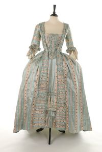 robe à la francaise, 1770s. Blue and white striped, figured and rose-sprigged silk satin, pleated an druffled robings edged in silk fly braid, petticoat with ruched furbelows.