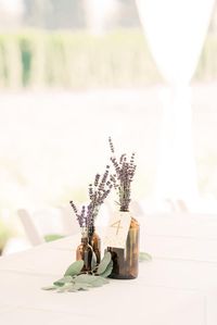 simple wedding reception center pieces with brown bottles and lavender