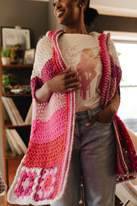 Elevate your wardrobe when you add the Sweetheart Cape, a cozy hooded poncho with granny square accents. This unique layer effortlessly blends comfort, style, and handmade charm to help you stand out from the crowd. Sick of wearing your same old fall jacket and need a change? Slip your arms into this color blocked poncho to change your mood for the better!

The Sweetheart Cape pattern is part of the Happy Place pattern collection, designed to complement Happy Place Apricity Yarn.