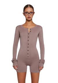 This romper has a stretchy knit construction with ribbed knit cuffs and collar, long sleeves, and front button closures.