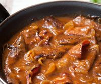 Liver and bacon with onion gravy. This recipe calls for using ketchup in the sauce, which I will not use, subbing for the same amount of tomato paste instead. If you caramelize the tomato paste until it turns a darker red, it gives the sauce a taste of something that has cooked for a longer period of time. I also will add a splash of red or white wine to the sauce, right after I caramelize the tomato paste.