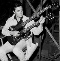 Elvis Presley playing a double-neck Gibson guitar.  #Elvis #ElvisPresley #Gibson