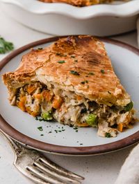 This classic chicken pot pie recipe features a double layer of buttery, flaky pie crust, with tender chicken and vegetables in a rich, creamy homemade sauce. It's the ultimate comfort food, perfect for a cozy family dinner or special occasion!