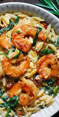 Creamy Tuscan Shrimp Pasta (Orzo) with Sun-Dried Tomatoes, Artichokes, and Spinach (30-Minute One-Pan Meal). Italian-inspired Autumn comfort food made with orzo pasta. This pasta dish is an easy weeknight meal to make during colder months of the year (Fall and Winter). #shrimppasta #pasta #comfortfood #creamyshrimppasta #creamypasta #orzo #orzorecipes #orzoideas #dinners #maindishes #maincourses #Italianfood #Italianrecipe