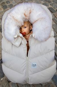 Toss all the blankets and instead envelope your baby in this cozy wind-beating cocoon wrap lined in plush fleece and trimmed in faux fur. Contoured fit removes any material between baby and car seat (sold separately) Elastic base makes for easy installation and removal Zip front closure with chin guard Side shoulder zip closures allow for uncovering baby's head Lined, with synthetic insulation 100% nylon with 100% polyester faux-fur trim Machine wash, tumble dry Imported Kids' Wear