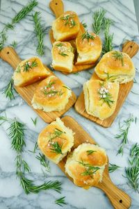 Buttery Buns Pull-apart butter dinner rolls made with rosemary butter and chunky sea salt are an easy recipe for celebrating Easter and Mother's Day! You'll impress your guests with these golden butter dinner rolls that taste straight like they are from a local bakery, but are homemade and take less than thirty minutes to prepare.    this 