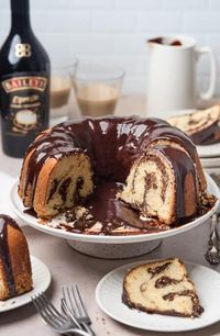 brownie swirl cake on a platter with a slice taken out