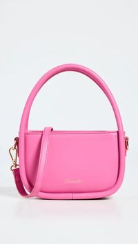 Add some glamour to your date night look with the Madamette Play Purse in pink. This stylish shoulder bag features faux leather material with gold-tone hardware, a fold-over flap with magnetic closure, and a zip interior pocket to keep your essentials organized. The optional, adjustable strap allows for versatile wearing options. Shopbop affiliate #DateNightPurse #MadametteBags #ShoulderBags