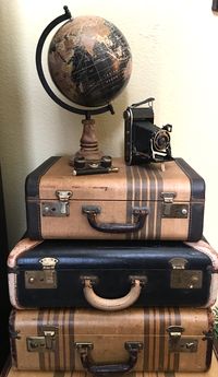 Vintage suitcases from 1940’s and 1950’s with vintage camera, opera glasses and pretty black globe add to my fall decor