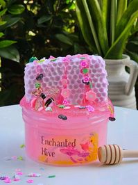 This name of this Slime Kit is perfect for spring! This is what I imagine an enchanted fairy garden hive would look like.  Comes With: Super fun Jelly slime base, with a realistic light pink clay honeycomb piece. Also comes with a pink and gold bee charm, whimsical spring garden sprinkles, a green leaf, and a 1oz pink clear Slime with holographic glitter.  Scented: Pinkest Coconut Calypso with a hint of strawberry.