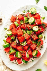 Fresh watermelon and cucumber are tossed with lemon and mint and served over a bed of silky whipped feta. For all of you fellow watermelon feta salad lovers out there...consider this twist on the classic