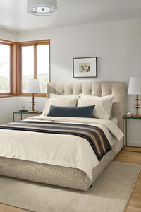 Soft fabric upholstery embellished with tufting puts a modern twist on a classic style. Featuring quality craftsmanship, the Avery bed adds texture and color to your room. No box spring required. An optional drawer at the foot adds extra storage.

