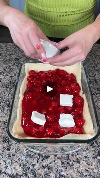 10M views · 1K comments | easy 1 pan dessert hack! | easy 1 pan dessert hack!

Cindy shows the easiest hack to make a yummy cheesecake! | By Kristin's Friends | Have some butter at the bottom
of my baking dish and all we going to do here this is so
great we just going to unroll this dough oops like that
that's fine if it breaks apart put one here We're going to put
the rest here like this. Great. Is that the right way? I think
it is. Alright. So, this is going to be basically the
crust. I'm about to show y'all the best dessert hack y'all
ever going to see, alright? So, two cans of crust and dough.
One goes right on the bottom. Next, we have a can of cherry
pie filling, alright? And y'all can use whatever kind you like.
I just, cherry is my favorite but you can use whatever you'd
like. Alri